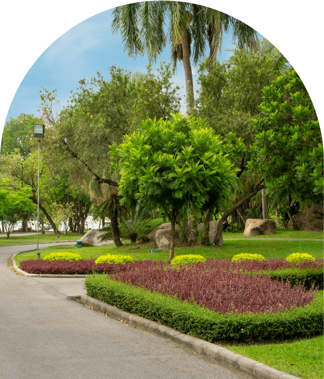 Landscaped park path with lush greenery.